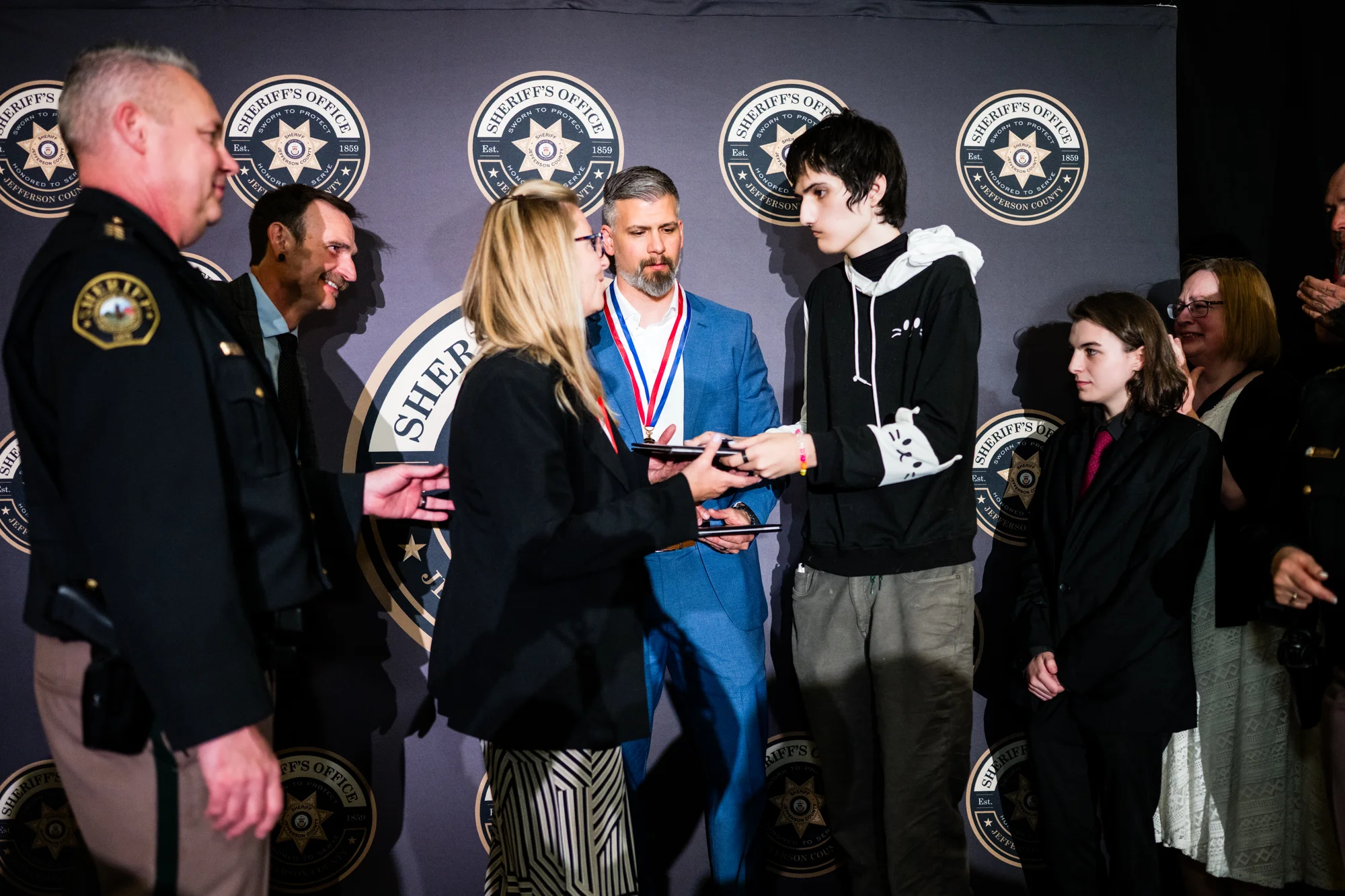 Deputies Hammetter and DeNuzzi presenting lifesaving awards to Evergreen High School shooting survivor Matthew Silverstone