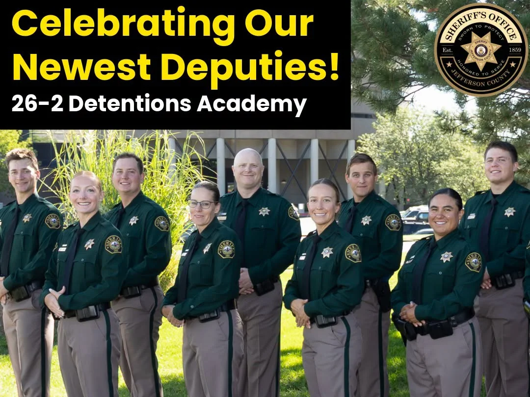 Graphic reading "Celebrating Our Newest Deputies! 26-2 Detentions Academy" above the nine graduates in green and tan JCSO uniforms, standing in a line on a lawn, with the Sheriff's Office seal