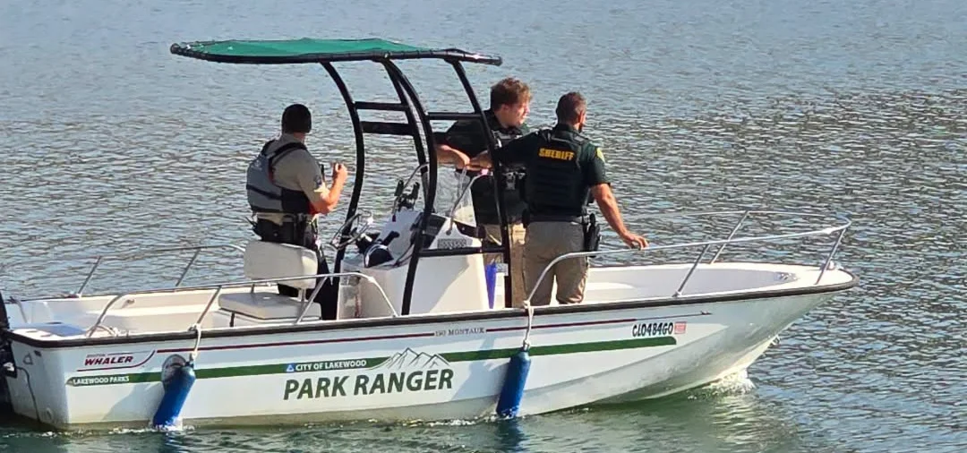 A JCSO deputy and two others aboard a City of Lakewood Park Ranger patrol boat on the water at Soda Lakes