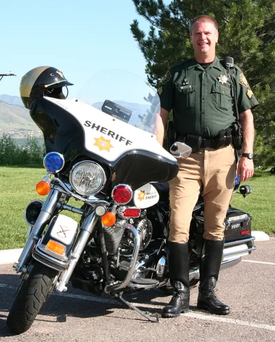 Portrait of Sergeant David M. Baldwin on his police motorcycle
